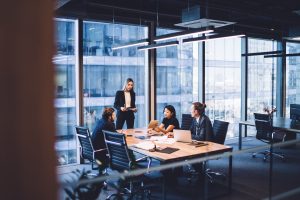 A group of colleagues in suits, in an office, working